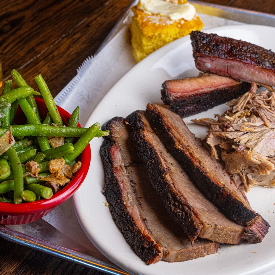 Barbecue plate with brisket, pulled pork, ribs and green beans